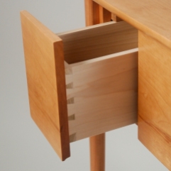 A joinery detail of the poplar drawer side. You open the drawer by pulling on the lip milled into the bottom of the cherry drawer front.